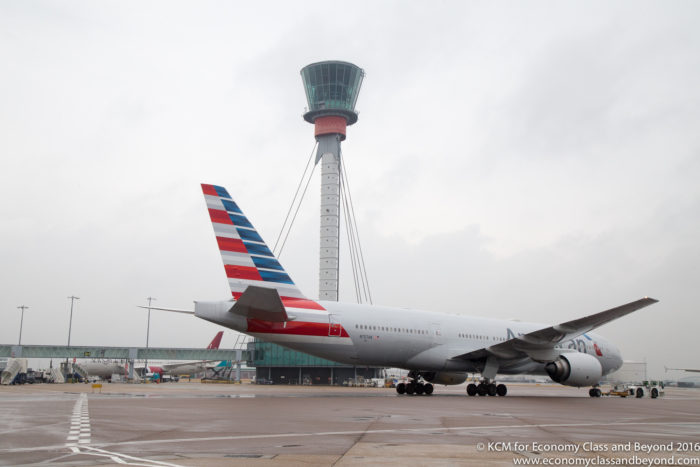 American Airlines Boeing 777 being towed with Heathrow Tower in the background - Image, Economy Class and Beyond