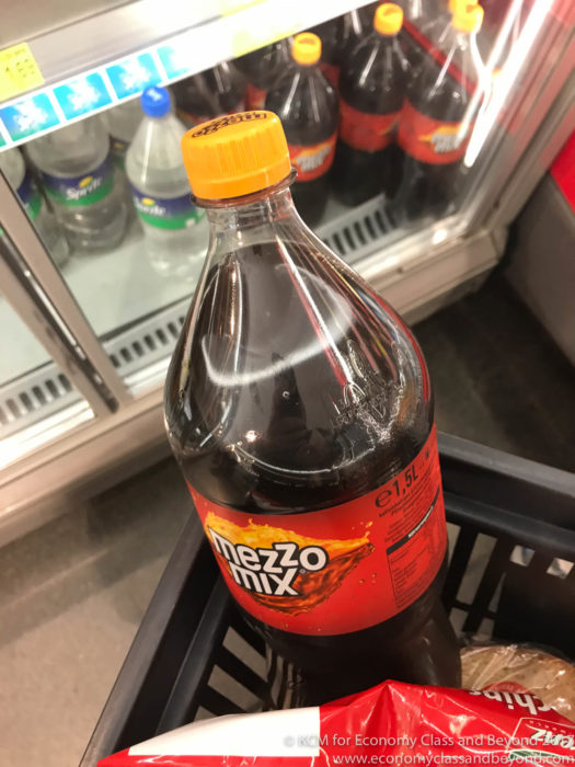 a bottle of soda in a grocery cart