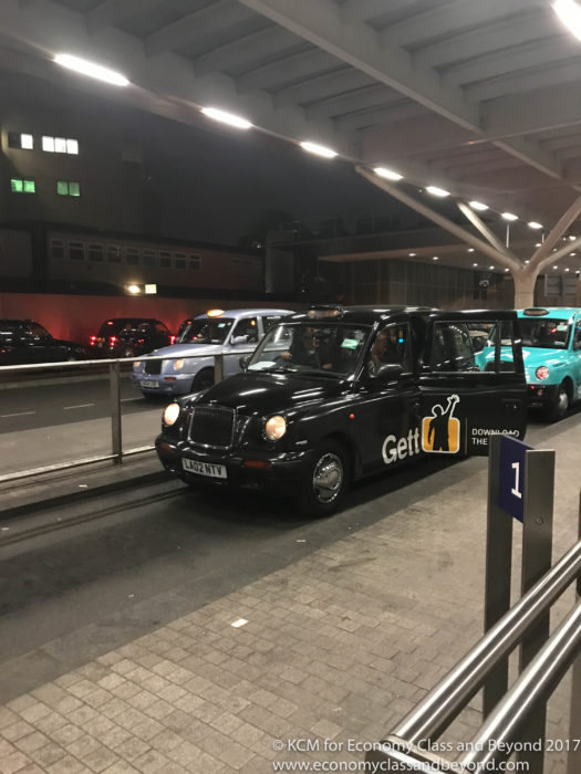 a black taxi cab on a street