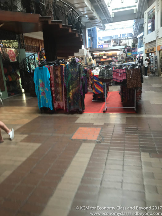 a store with clothes on swingers