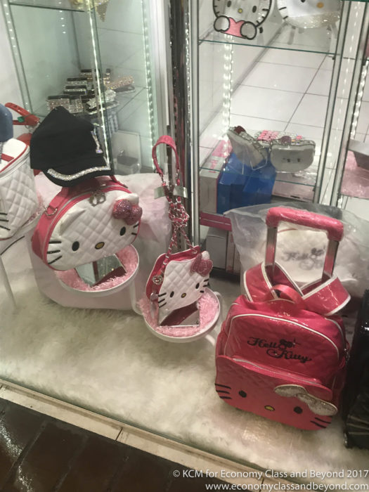 a display case with hello kitty bags and purses