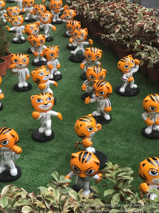 a group of small orange and white tiger figurines