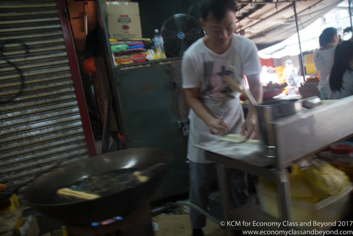 a man cooking food in a market