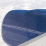 an airplane wing with a blue object