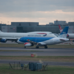 a group of airplanes on a runway