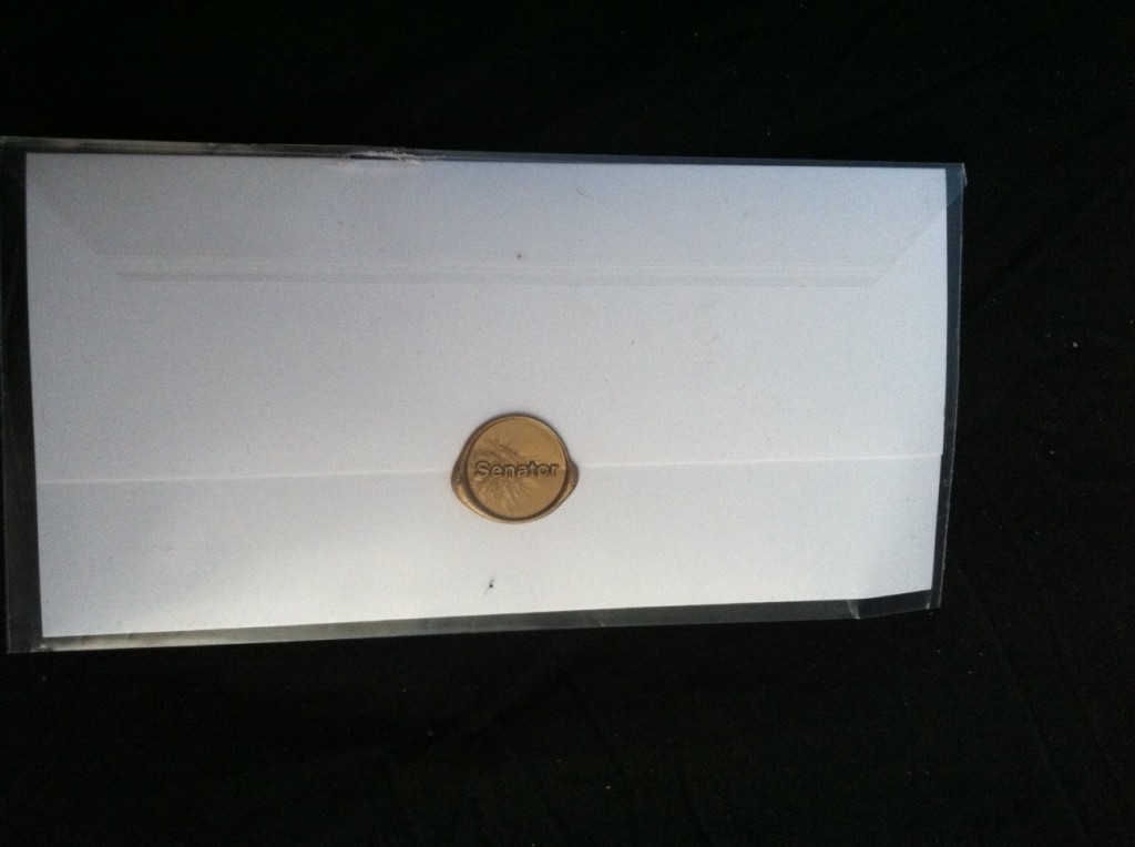 a white envelope with a coin on it