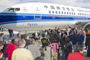 a group of people standing around an airplane