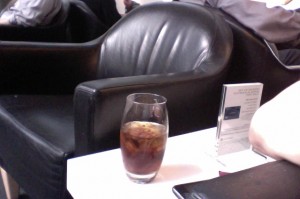 a glass of brown liquid on a table