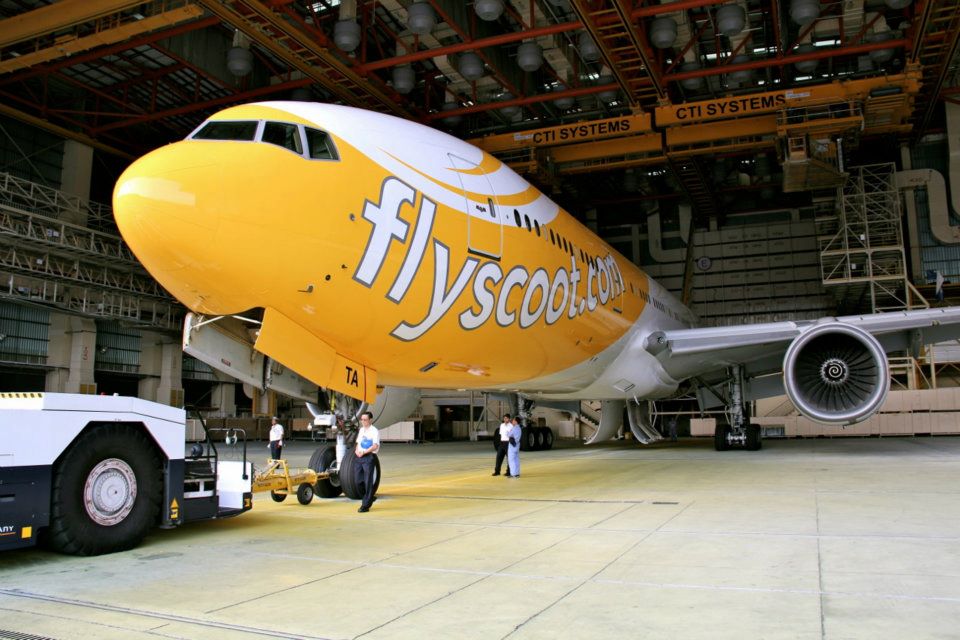 a yellow and white airplane in a hangar