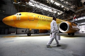 a man walking past an airplane