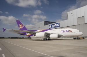a large airplane parked in front of a building