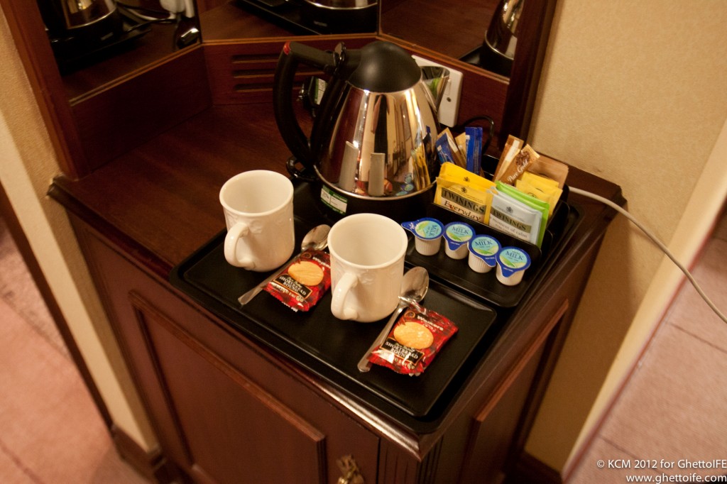 a tray with coffee cups and teapots on it