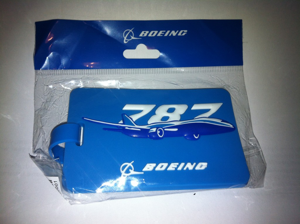 a blue luggage tag with a plane in it