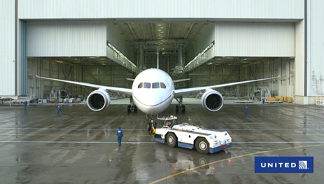 a large white airplane in a hangar