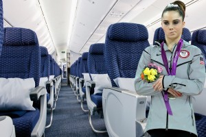 a woman standing in an airplane with a bunch of flowers