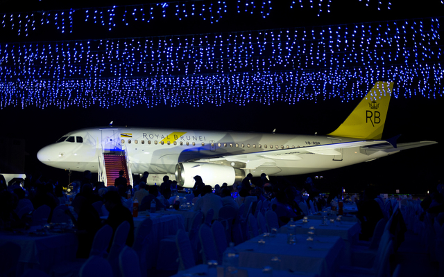 a large airplane in a room with tables and chairs