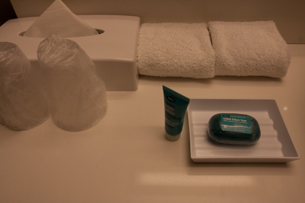 a soap and a bottle of shampoo on a white counter