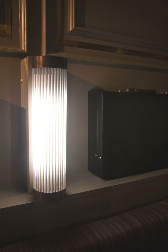 a light on a shelf next to a briefcase