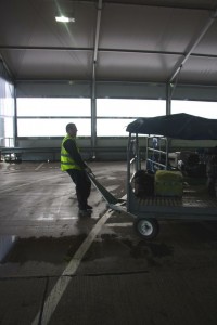 a man in a yellow vest pushing a cart
