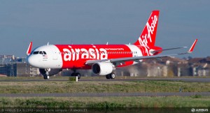 a red and white airplane on a runway