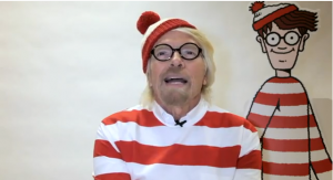 a man wearing a red and white striped shirt and hat