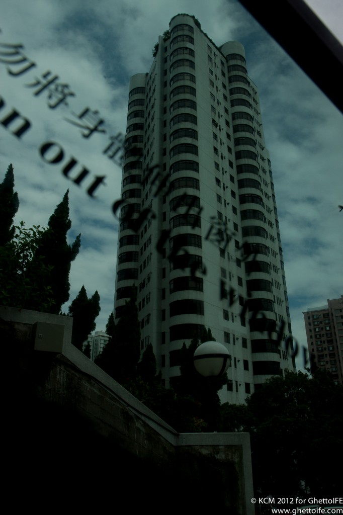 a tall building with a street light and trees