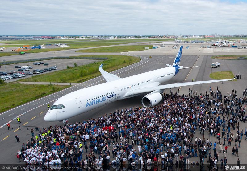 a large crowd of people around an airplane