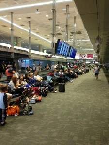 a group of people sitting on the floor in an airport