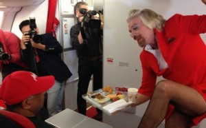 a man in red suit holding a tray of food