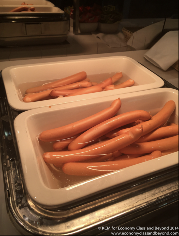 a group of hot dogs in a white container