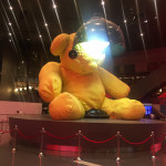 a large stuffed bear with a light on its head