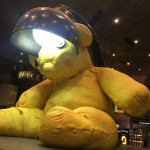 a yellow stuffed bear with a lamp on its head