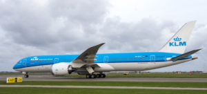 a large blue and white airplane on a runway