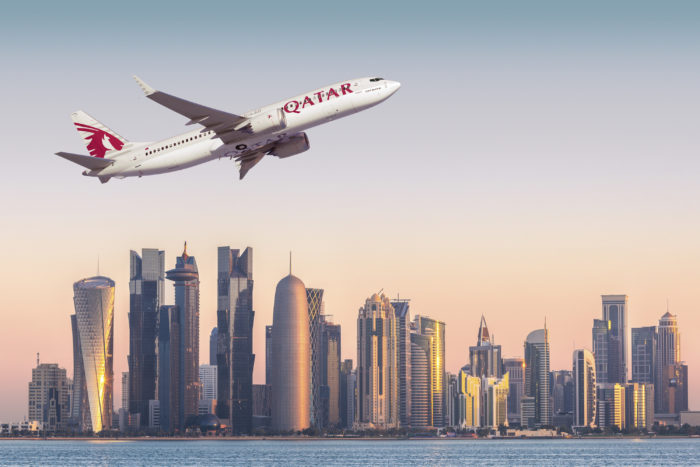 Doha financial center skyline at sunrise, Qatar Airways Boeing 737 MAX 8