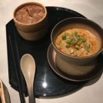 a bowl of soup and a container of food