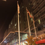 flags on poles in front of a building