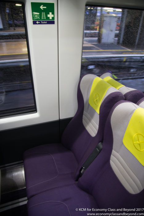 a purple and yellow seats on a train