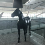 a statue of a horse with a lamp on its head