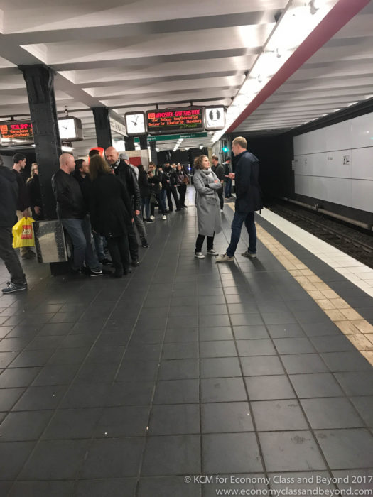 a group of people standing in a subway station