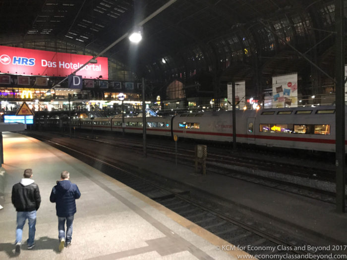 a man walking on a platform at a train station