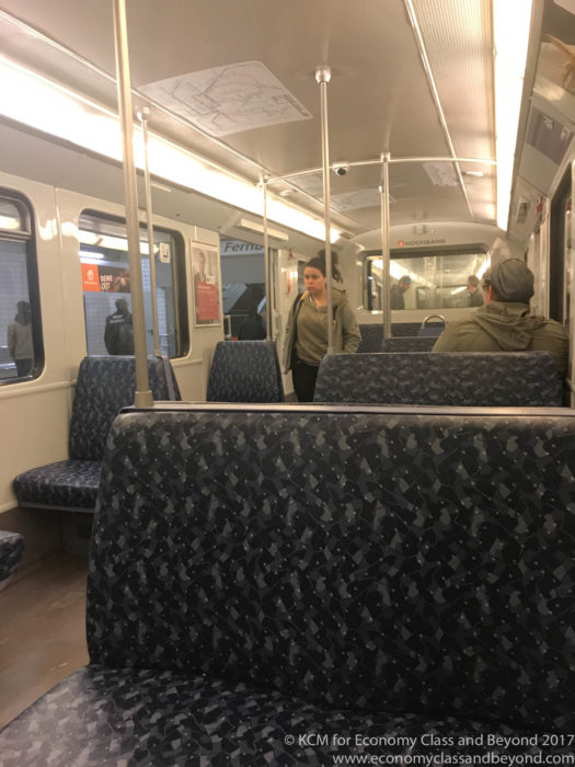 people inside a train with people standing on the seats