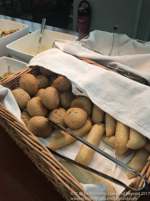 a basket of bread rolls and breadsticks