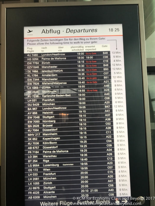 a screen with a sign with a number of flights