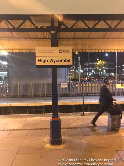 a sign with a sign and a person walking on the platform