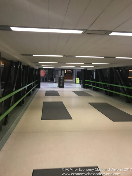 a hallway with a green railing