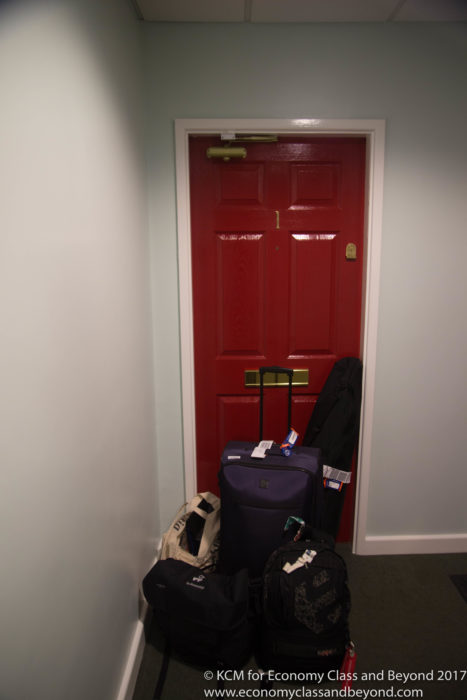 a red door with luggage on it
