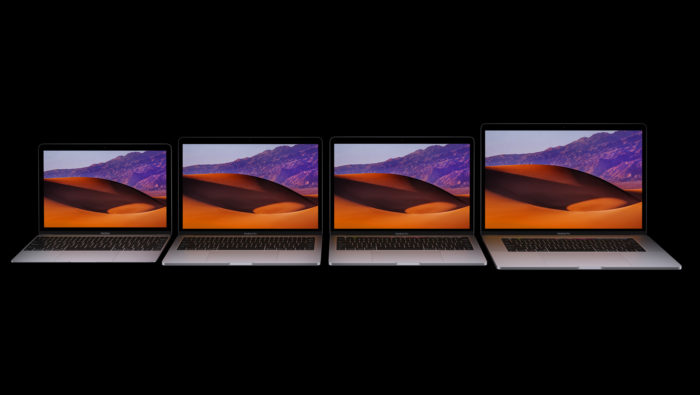 a row of laptops with desert images on them