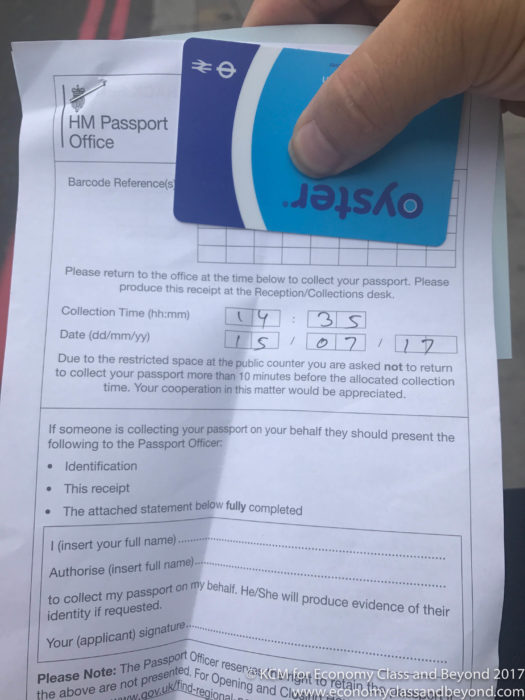 a hand holding a piece of paper with a blue card on it