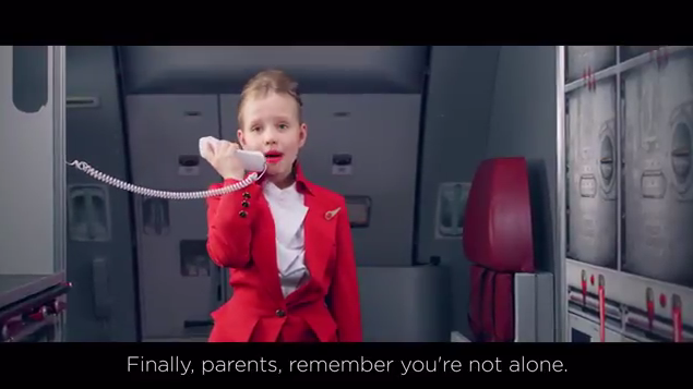 a girl in a red suit talking on a phone