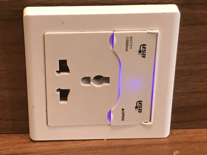 a white outlet with a blue light